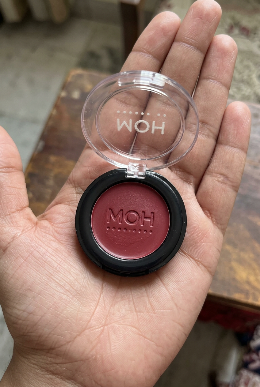 Rouge compact held in a palm
